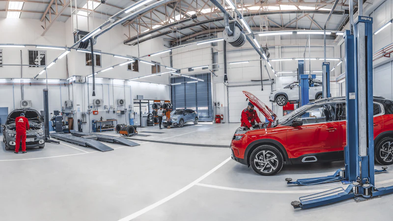 Mechanics working on cars in a repair workshop
