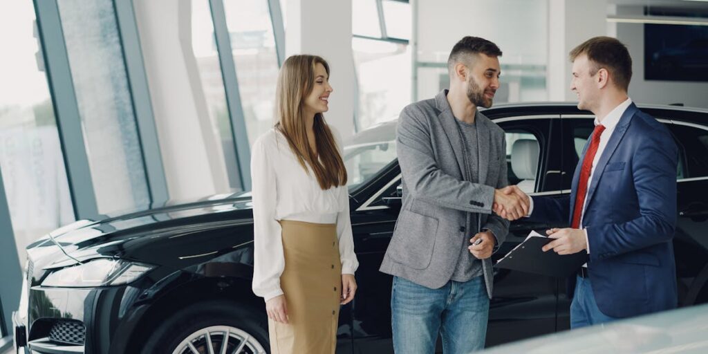 A customer completing a car purchase at a dealership
